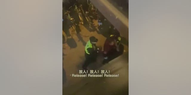 Chinese law enforcement taking the BBC reporter away after having arrested him on the street for coving the anti-lockdown protests in Shanghai.