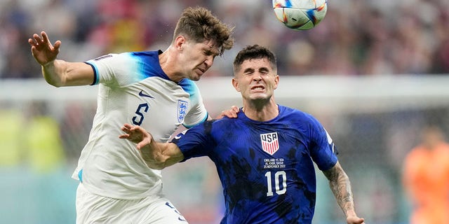 John Stones of England vies for the ball with Christian Pulisic of the United States during the World Cup Group B match at Al Bayt Stadium in Al Khor, Qatar on November 25, 2022.
