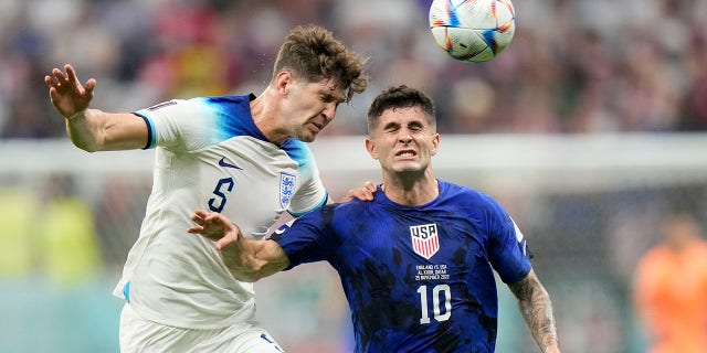 England's John Stones vies for the ball with Christian Pulisic of the United States during the World Cup Group B match at Al Bayt Stadium in Al Khor, Qatar, Nov. 25, 2022.