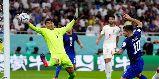 Christian Pulisic shoots past Iran's goalkeeper Alireza Beiranvand in Doha, Qatar, Tuesday, Nov. 29, 2022.