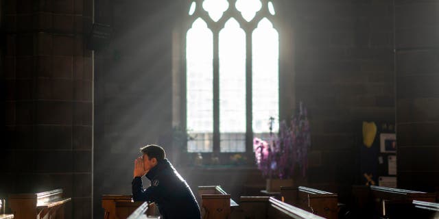 A man prays in a church in Birmingham, England, on Christmas Eve, Dec. 24, 2018. "As difficult things happen, we know they will not vanquish us since your strength dwells within us," Fr. Kirby prayed. "Fortify us. Bless us with your grace."