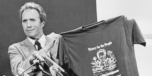 Clint Eastwood holds up a T-shirt proclaiming him mayor of Carmel-by-the-Sea, California, during his acceptance speech on April 9, 1986.