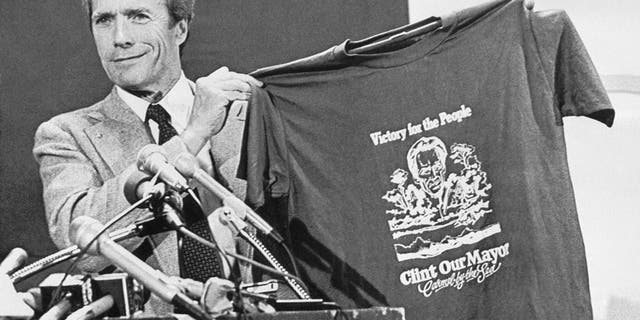 Clint Eastwood holds up a T-shirt proclaiming him mayor of Carmel-by-the-Sea, California, during his acceptance speech on April 9, 1986.