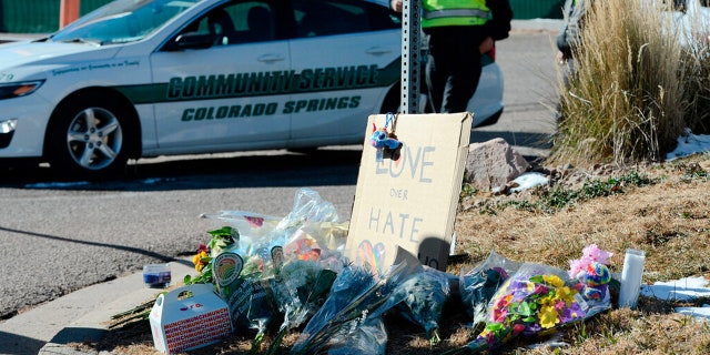 Flowers and a sign reading "love over hate" lay near a gay nightclub in Colorado Springs, Colo., Sunday, Nov. 20, 2022 where a shooting occurred late Saturday night. 