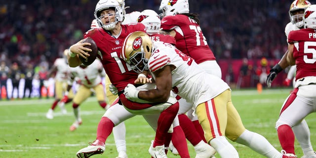 Kevin Givens #90 of the San Francisco 49ers sacks Colt McCoy #12 of the Arizona Cardinals during the third quarter at Estadio Azteca on November 21, 2022 in Mexico City, Mexico.