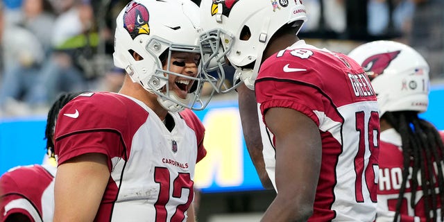 Arizona Cardinals quarterback Colt McCoy (12), left, celebrates after throwing a touchdown pass to wide receiver A.J. Green, right, during the first half of an NFL football game Sunday, Nov. 13, 2022, in Inglewood, Calif. 