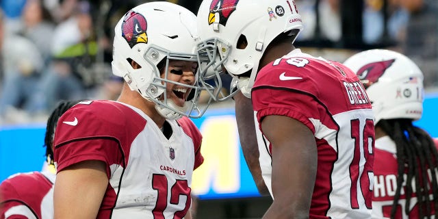 Arizona Cardinals quarterback Colt McCoy (12), left, celebrates after throwing a touchdown pass to wide receiver A.J. Green, right, during the first half of an NFL football game Sunday, Nov. 13, 2022, in Inglewood, Calif.
