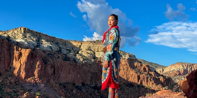 ShanDien LaRance from New Mexico stands near a rocky landscape.