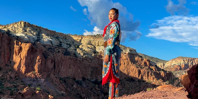 New Mexico local ShanDien LaRance stands near a rocky landscape.