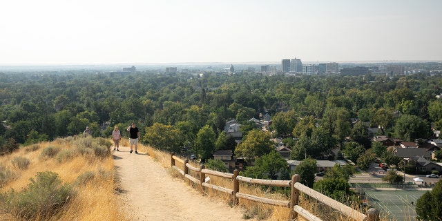 A couple walks a trail in Camel's Back Park in Boise, Idaho.