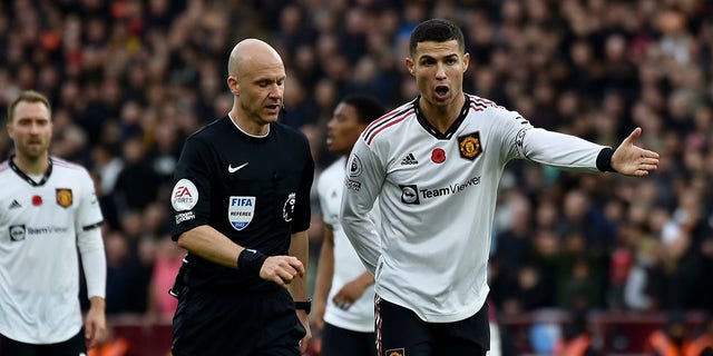 Manchester United's Cristiano Ronaldo gestures to referee Anthony Taylor during the English Premier League soccer match between Aston Villa and Manchester United at Villa Park in Birmingham, England, Sunday, Nov. 6, 2022.