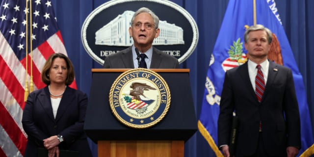 US Attorney General Merrick Garland, center, FBI Director Christopher Wray, right, and Deputy Attorney General Lisa Monaco hold a press conference at the US Department of Justice.