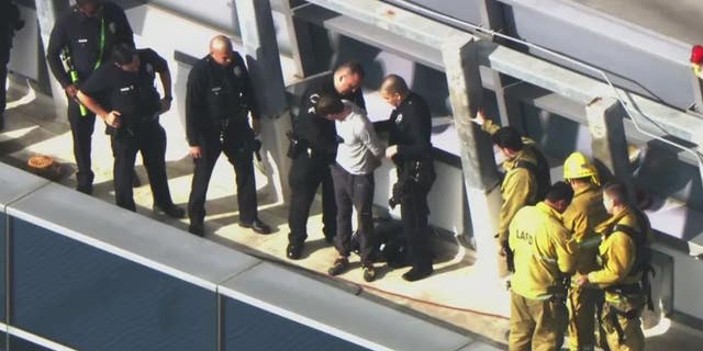 A man who climbed the side fo a downtown Los Angeles hotel was greeted by police officers when he got to the top.