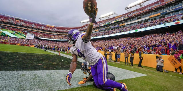 Minnesota Vikings running back Dalvin Cook (4) holds up the ball after making a touchdown catch against the Washington Commanders during the second half on Nov. 6, 2022, in Landover, Maryland.