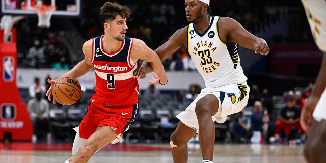 Wizards forward Deni Avdija dribbles against Indiana Pacers center Myles Turner at Capital One Arena in Washington, D.C., Oct. 28, 2022.