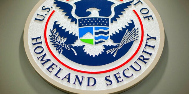 FILE: The Department of Homeland Security logo is seen during a news conference in Washington, Feb. 25, 2015.