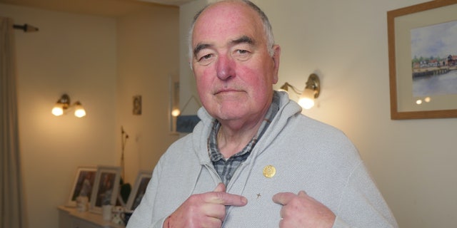 Derek Timms, a 73-year-old businessman-turned-chaplain, fought back after a U.K.-based hospice charity threatened him with "consequences" and "re-training" for wearing a small golden cross pin.