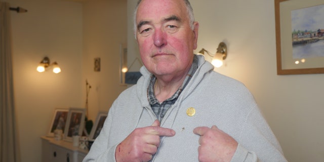 Derek Timms, a 73-year-old businessman-turned-chaplain, fought back after a U.K.-based hospice charity threatened him with "consequences" and "re-training" for wearing a small golden cross pin.