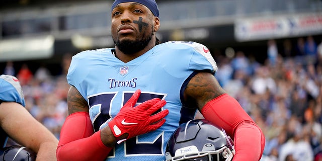 Tennessee Titans running back Derrick Henry listens to the national anthem as the team prepares to face the Cincinnati Bengals at Nissan Stadium in Nashville on November 27, 2022.