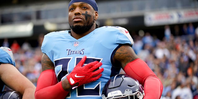 Tennessee Titans running back Derrick Henry, #22, listens to the National Anthem as the team prepares to face the Cincinnati Bengals at Nissan Stadium in Nashville, Tennessee on November 27, 2022.