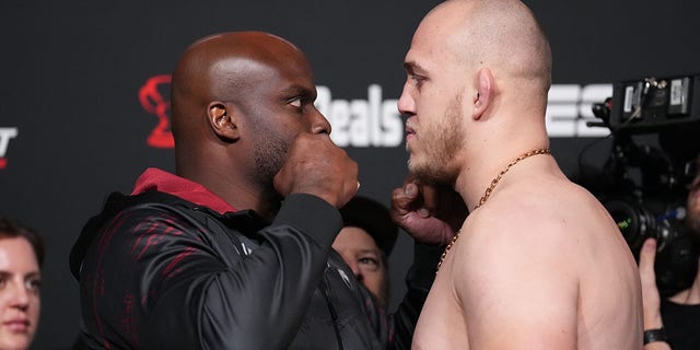 Competitors Derrick Lewis (left) and Serghei Spivac of Moldova face off in the UFC Fight Night weigh-in at UFC APEX on November 18, 2022 in Las Vegas.