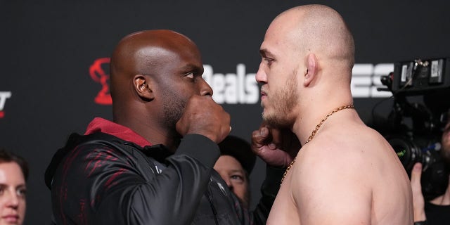 Opponents Derrick Lewis, left, and Serghei Spivac of Moldova face off during the UFC Fight Night weigh-in at UFC APEX Nov. 18, 2022, in Las Vegas.
