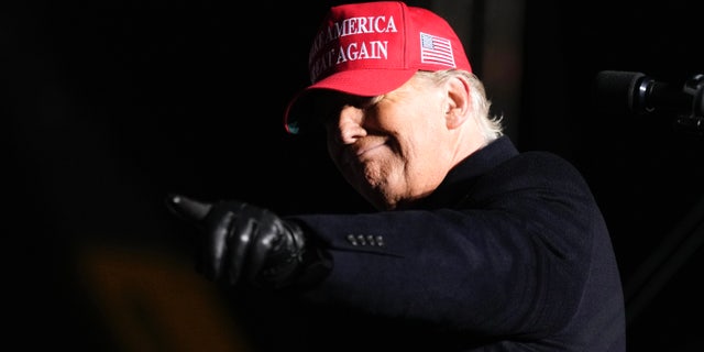 Former President Donald Trump reacts to a supporter during a rally, Thursday, Nov. 3, 2022, in Sioux City, Iowa. 