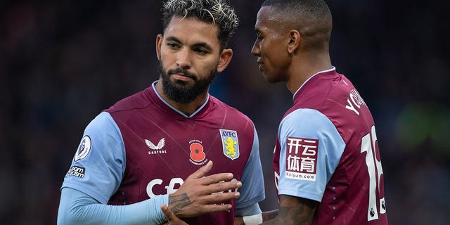 Douglas Luiz and Ashley Young of Aston Villa in action during the Premier League match between Aston Villa and Manchester United at Villa Park on November 6, 2022 in Birmingham, United Kingdom.