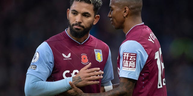 Douglas Luiz and Ashley Young, of Aston Villa, in action during the Premier League match between Aston Villa and Manchester United at Villa Park on Nov. 6, 2022 in Birmingham, United Kingdom.