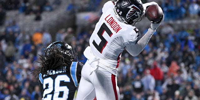 No. 5 Drake London of the Atlanta Falcons catches a touchdown over No. 26 Donte Jackson of the Carolina Panthers in the third quarter at Bank of America Stadium.