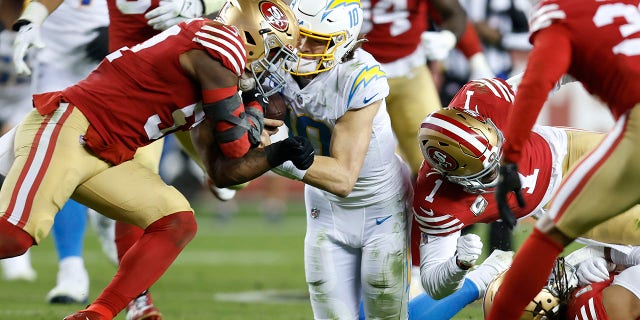 Los Angeles Chargers quarterback Justin Herbert is hit by San Francisco 49ers linebacker Dre Greenlaw in Santa Clara, California, Sunday, Nov. 13, 2022.