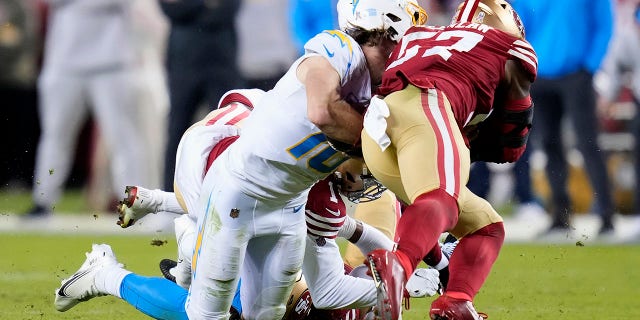 San Francisco 49ers linebacker Dre Greenlaw hits Los Angeles Chargers quarterback Justin Herbert in Santa Clara, California, Sunday, Nov. 13, 2022.