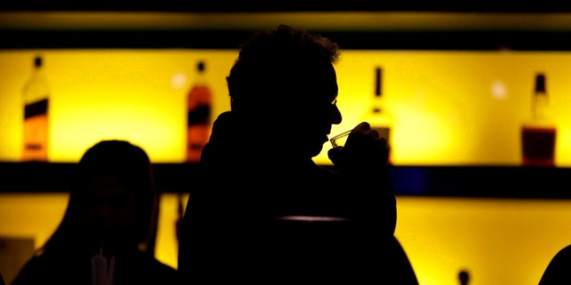 In this Nov. 30, 2017 photo, a patron sips his drink while having a meal at a bar in New Jersey.