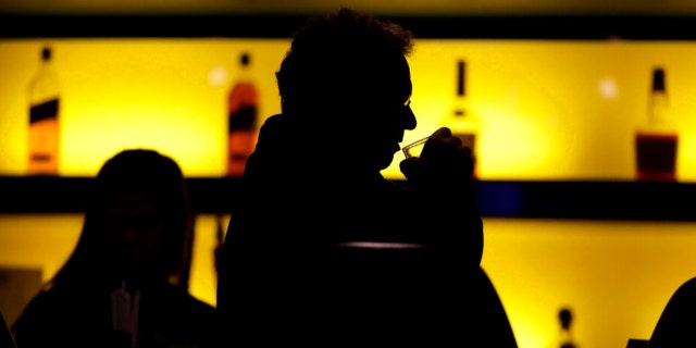 In this Nov. 30, 2017 photo, a patron sips his drink while having a meal at a bar in New Jersey.