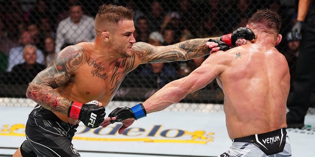 Dustin Poirier punches Michael Chandler in a lightweight bout during UFC 281 at Madison Square Garden on November 12, 2022 in New York City.