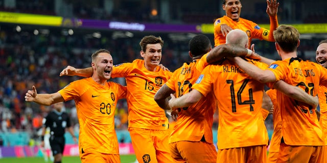 Netherlands celebrates a goal against Senegal at the World Cup in Qatar, where players are not allowed to wear a rainbow armband.