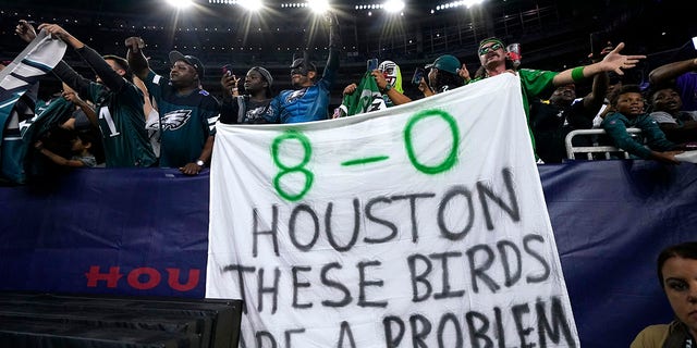 Philadelphia Eagles fans hold a sign after an NFL football game against the Houston Texans in Houston, Thursday, Nov. 3, 2022. 