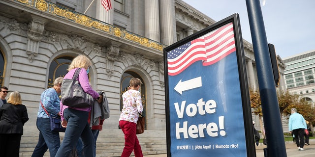 A voting sign is seen outside the San Francisco City Hall as early voting continues for 