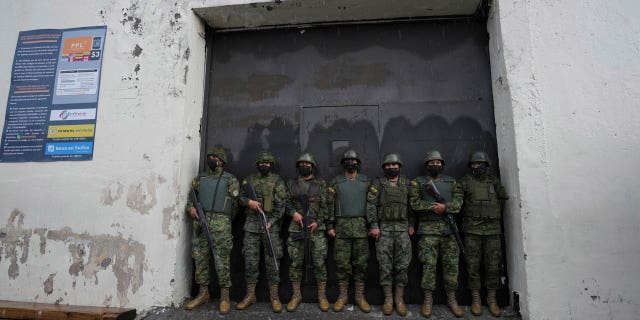 Soldiers guard an entrance to the Inca jail where eight inmates were killed during a prison riot, according to Police Commander Victor Herrera, in Quito, Ecuador, on Nov. 18, 2022.