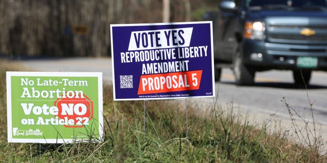 Opposing campaign signs supporting a proposed amendment to the Vermont constitution that would guarantee access to reproductive rights, including abortion, by the side of the road in on Nov. 3, 2022 in Middlesex, Vt.