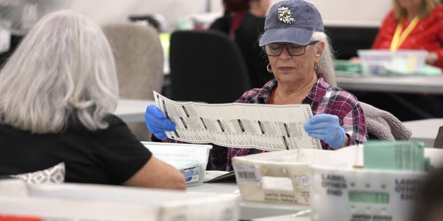 PHOENIX, ARIZONA - NOVEMBER 11: Election workers open mail-in ballots at the Maricopa County Tabulation and Election Center on November 11, 2022, in Phoenix, Arizona. Ballots continue to be counted in Maricopa County three days after voters went to the polls for the midterm election in Arizona. (Photo by Justin Sullivan/Getty Images)