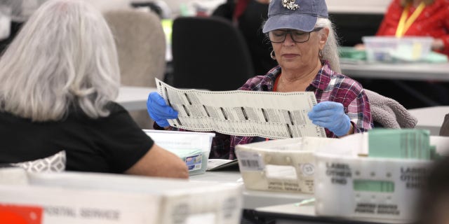 PHOENIX, ARIZONA - NOVEMBER 11: Election workers open mail-in ballots at the Maricopa County Tabulation and Election Center on November 11, 2022, in Phoenix, Arizona. Ballots continue to be counted in Maricopa County three days after voters went to the polls for the midterm election in Arizona. (Photo by Justin Sullivan/Getty Images)