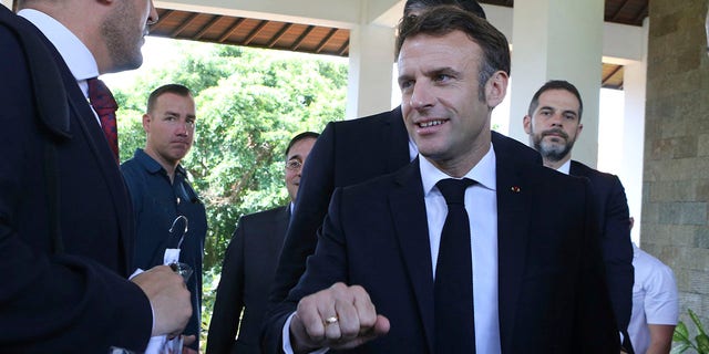 French President Emmanuel Macron, right, walks after an emergency meeting at Nusa Dua in Bali, Indonesia on Wednesday, Nov. 16, 2022. 