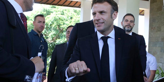 French President Emmanuel Macron, right, walks after an emergency meeting at Nusa Dua in Bali, Indonesia on Wednesday, Nov. 16, 2022. 