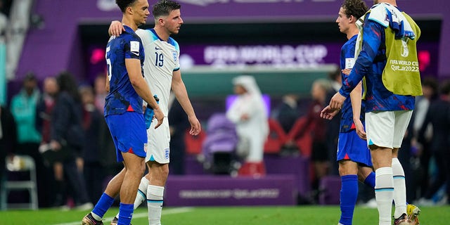 Antonee Robinson, of the United States, left, and England's Mason Mount, second from left, walk on the pitch at the end of the World Cup Group B soccer match between England and The United States, at the Al Bayt Stadium in Al Khor, Qatar, Friday, Nov. 25, 2022.
