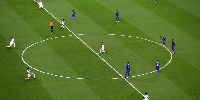 English players take a knee before kickoff during a FIFA World Cup Qatar 2022 Group B match against the U.S. at Al Bayt Stadium Nov. 25, 2022, in Al Khor, Qatar.