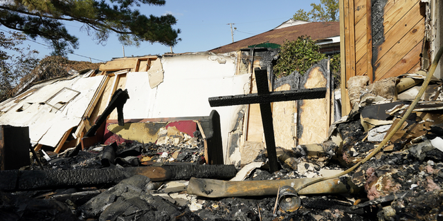 Melted siding, burned insulation, charred wooden beams and ashes of old hymnals and bulletins are all that remain at Epiphany Lutheran Church near midtown Jackson, Mississippi, on Nov. 8.