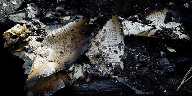 The ashes of old hymnals and missals are seen in the remains of the Epiphany Lutheran Church near midtown Jackson, Mississippi, on Nov. 8.