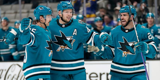San Jose Sharks defenseman Erik Karlsson, left, is congratulated by center Tomas Hertl, middle, and defenseman Jaycob Megna after scoring a goal during the first period of an NHL hockey game against the Anaheim Ducks in San Jose, California, Tuesday, Nov. 1, 2022.