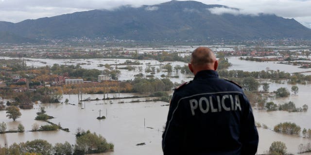 A policeman checks a flooded area near the city of Shkodër in northwestern Albania November 21, 2022.